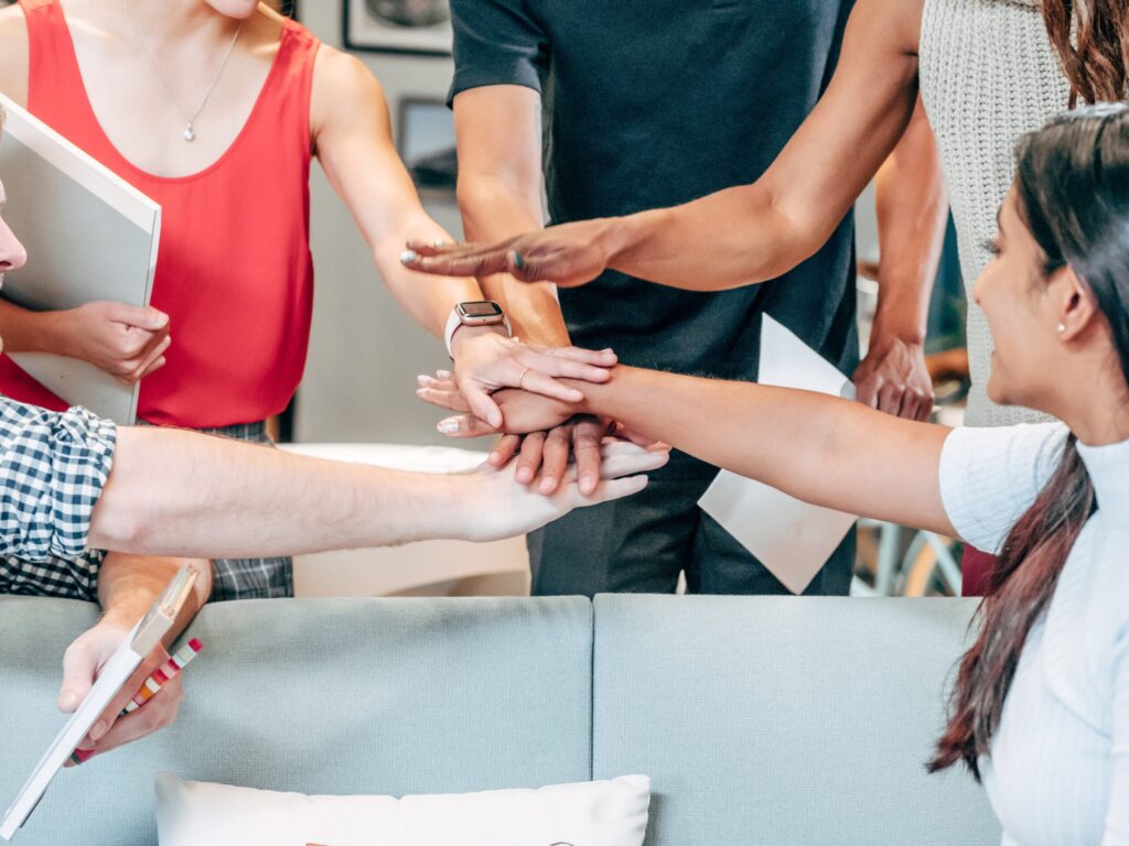 A business team combining hands to demonstrate team work