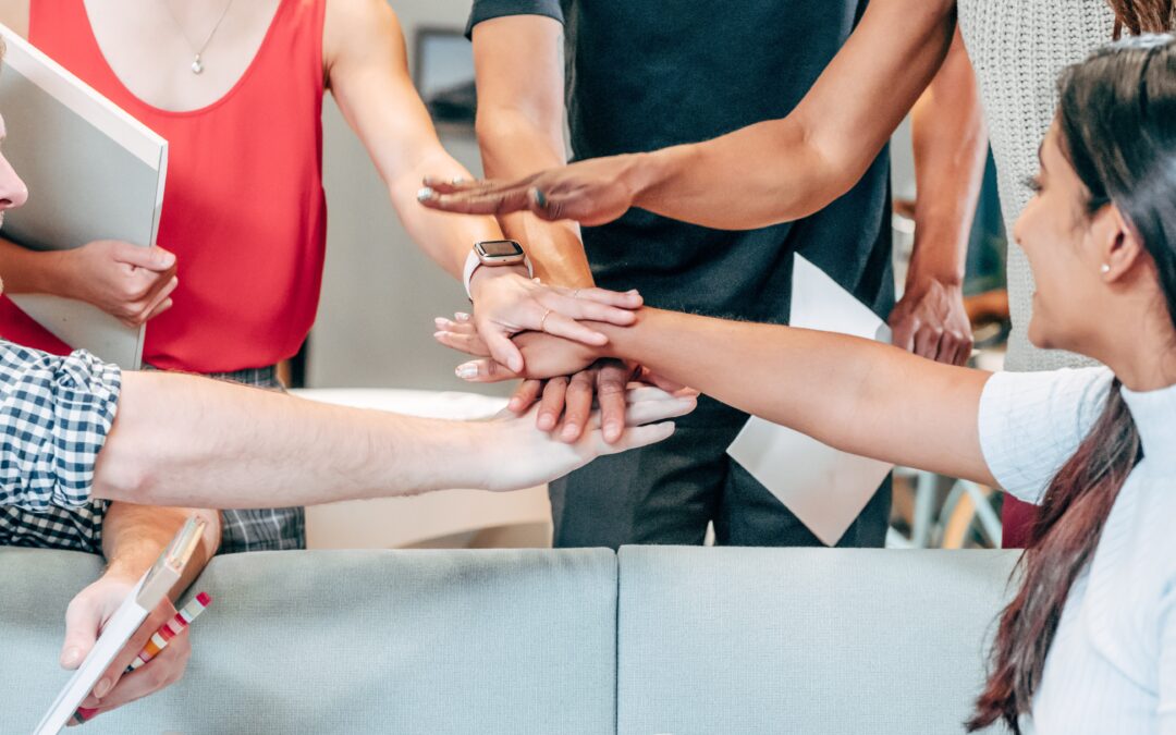 A business team combining hands to demonstrate team work