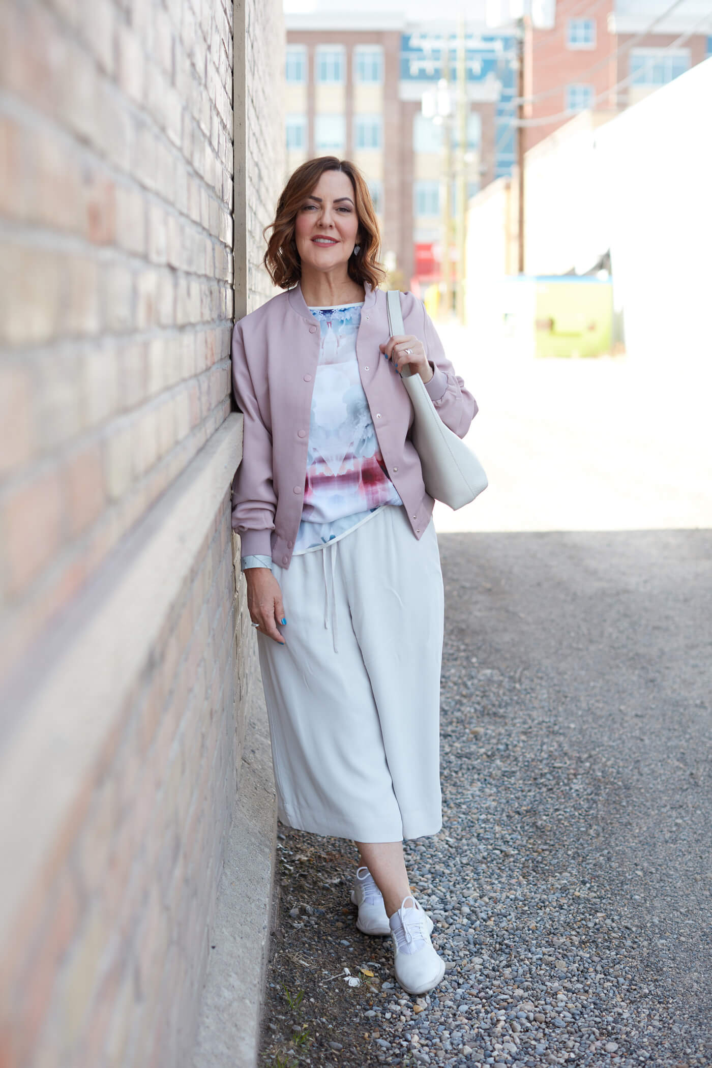 Susan McGuire Leaning Against Brick Wall